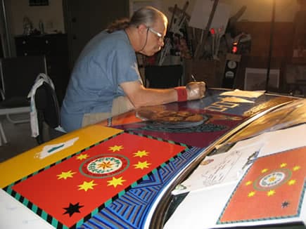 Dr. Bob painting symbols of our Native American founding fathers.