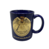Product image of the front of the reverse of the Great Seal mug. It is a vibrant blue color with a monochromatic gold rendering of the reverse of the Great Seal on the front. Underneath, is "21stcenturyradio.com"